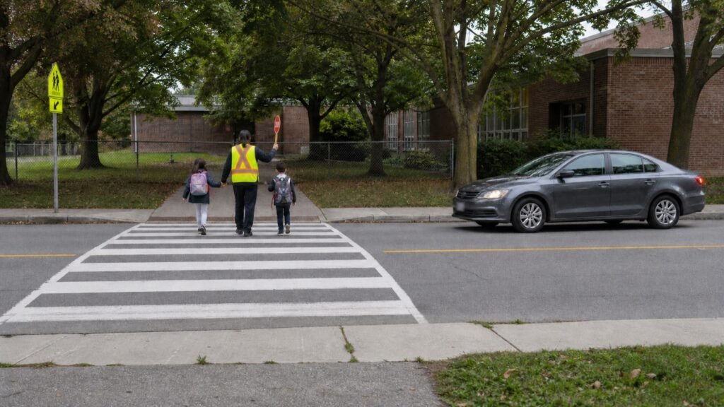 Driver stopped before a school crossing guard and children at an Ontario pedestrian crossover